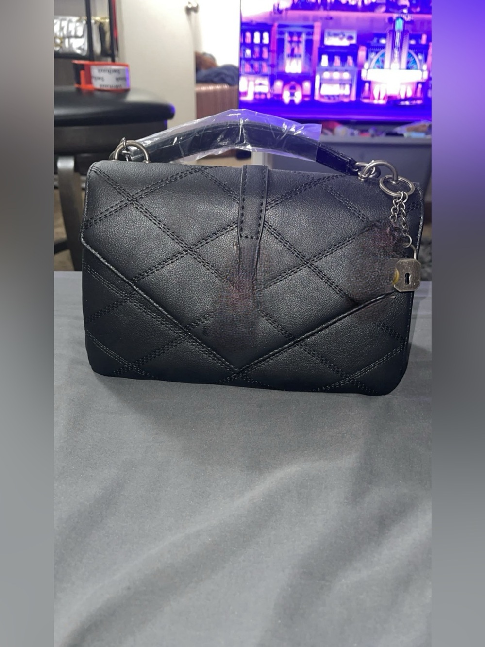 Quilted Black Shoulder Bag with Top Handle and Padlock Charm
